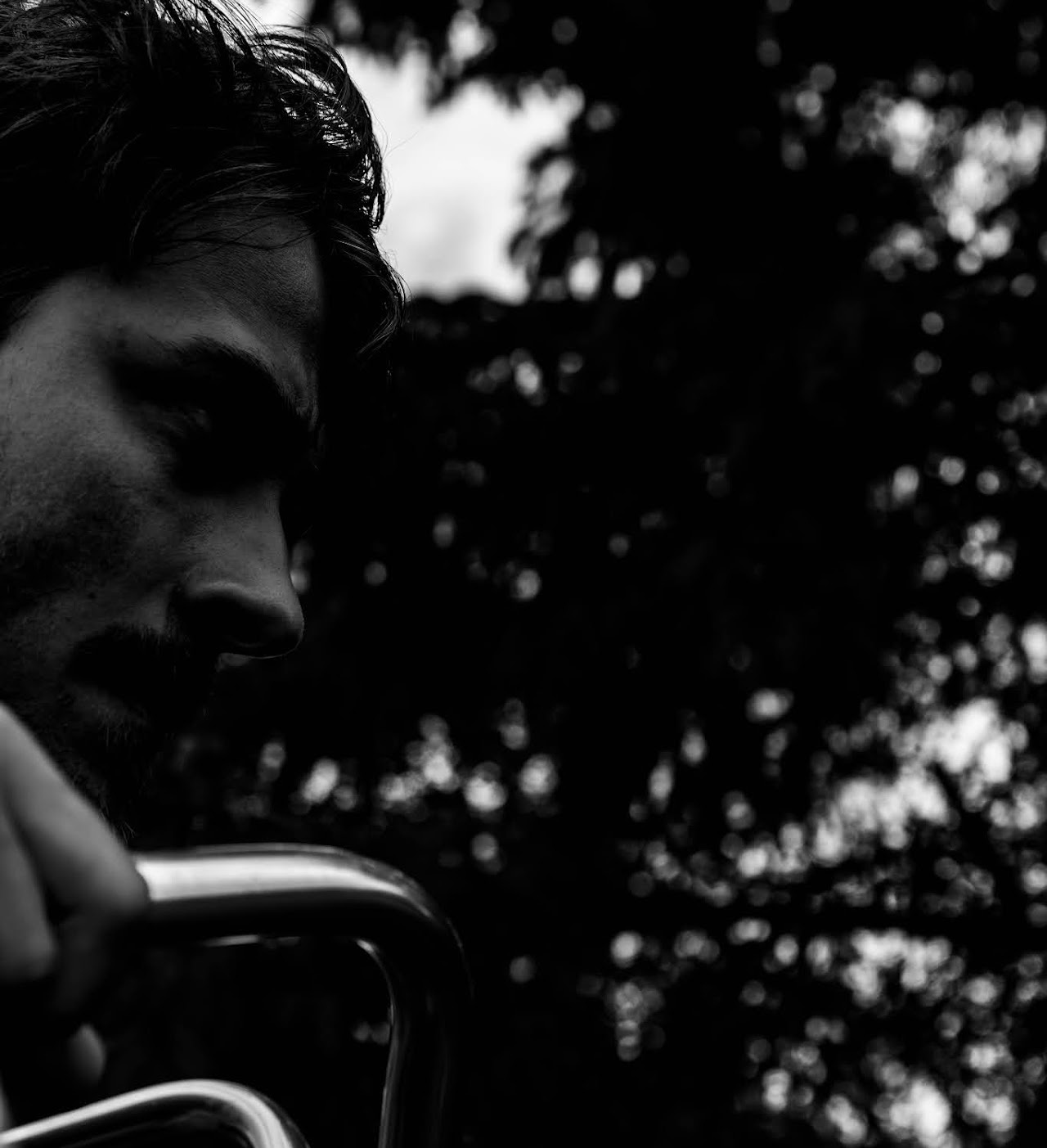 High-contrast monochrome close profile of a man holding a trumpet