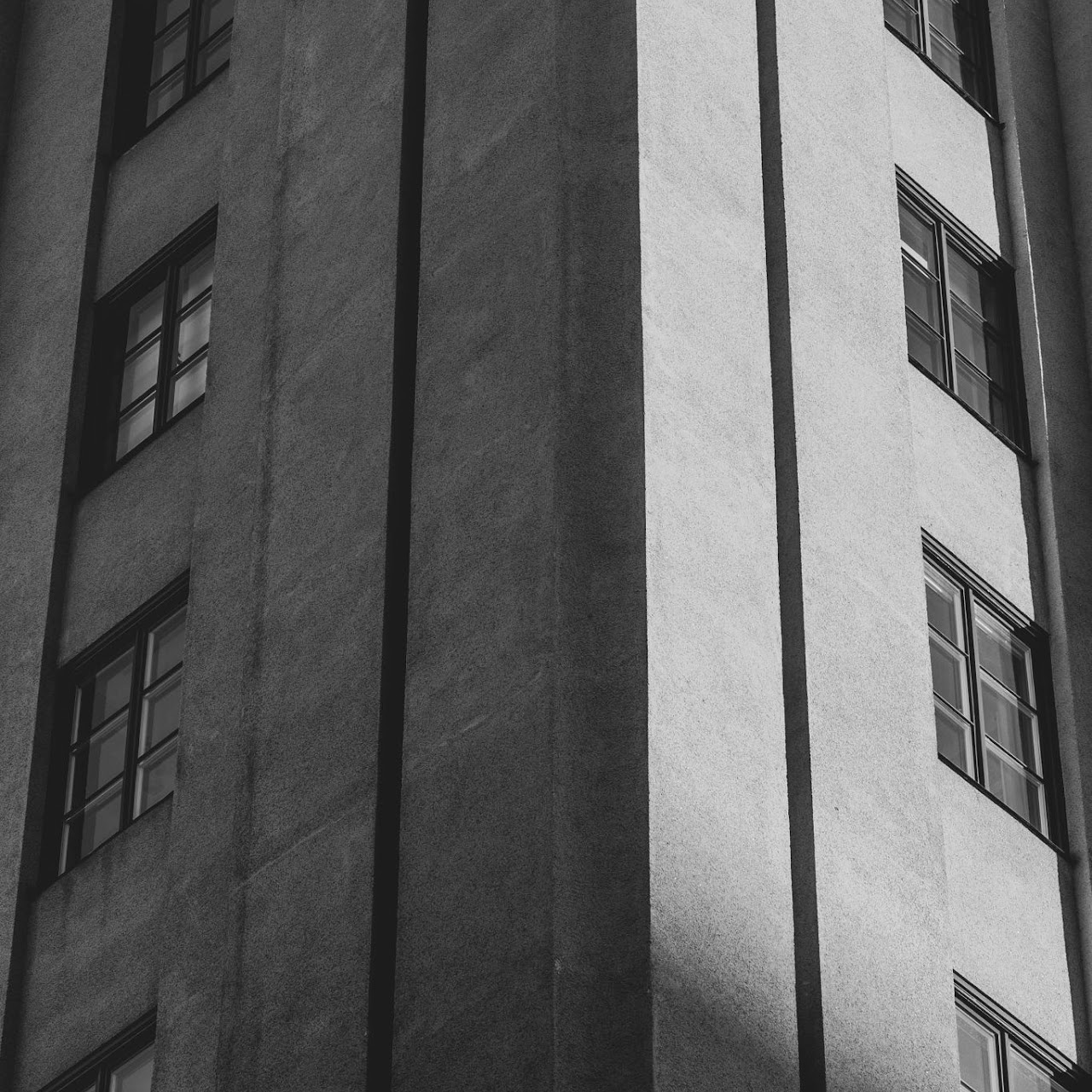 Monochrome facade divided by a sharp vertical shadow
