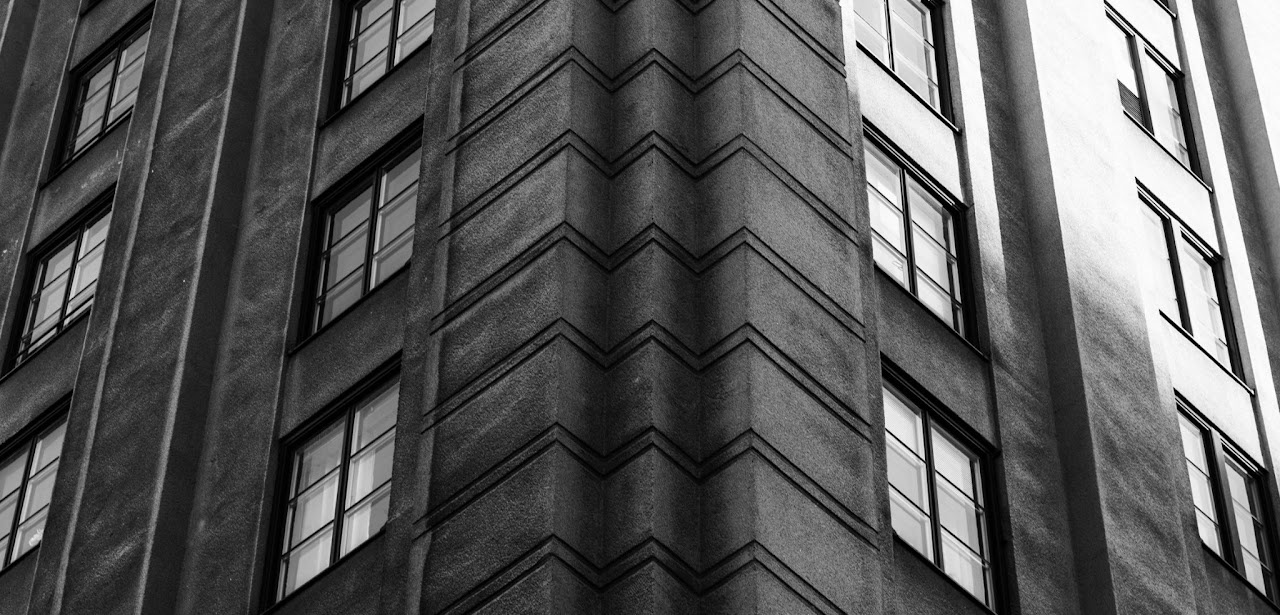Monochrome architectural corner with deep vertical shadows